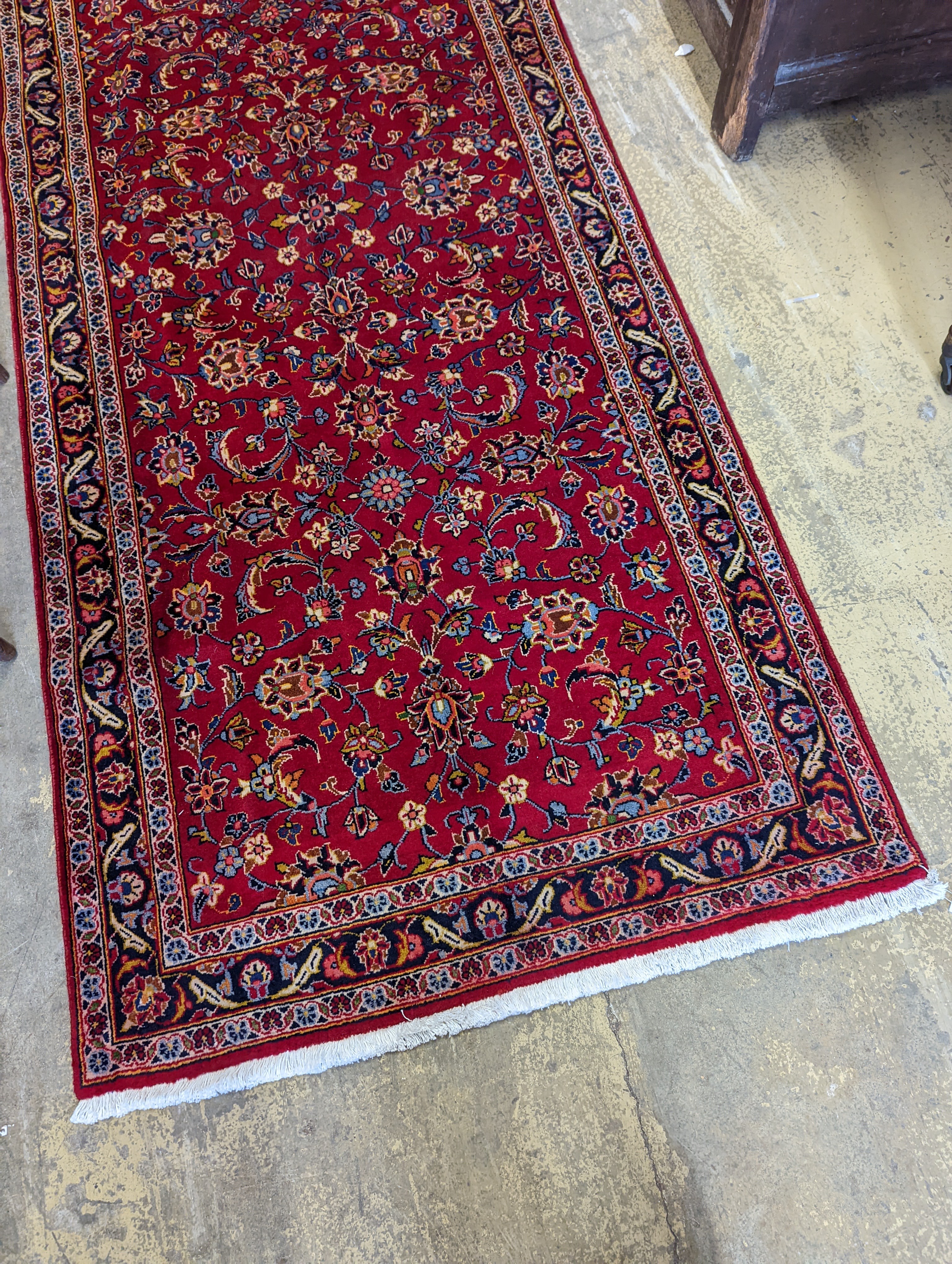 A Kashan red ground runner, 340 x 101cm